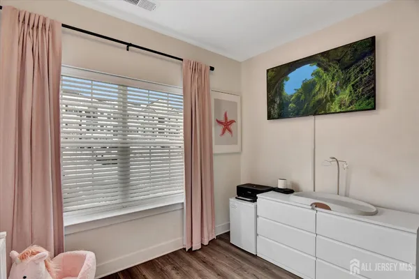 a room with a bed and a flat screen tv