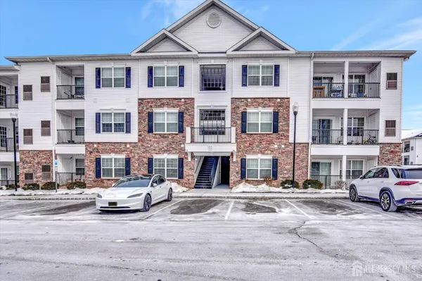 a front view of a residential apartment building with a yard