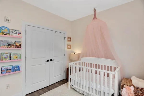 a bedroom with a bed and book shelf