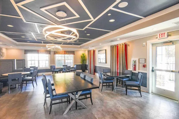 a living room with lots of furniture and view of kitchen