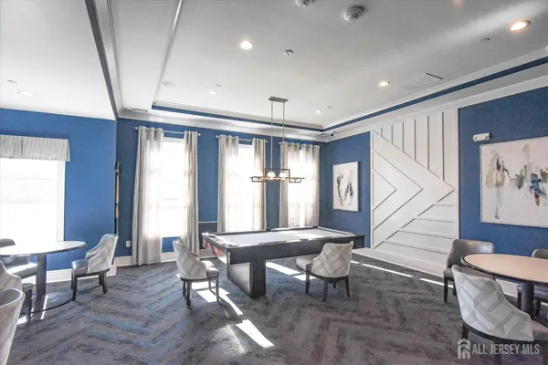 a view of tennis court with houses in the background