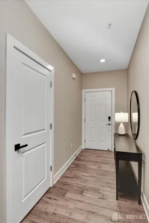a view of a room with wooden floor and furniture