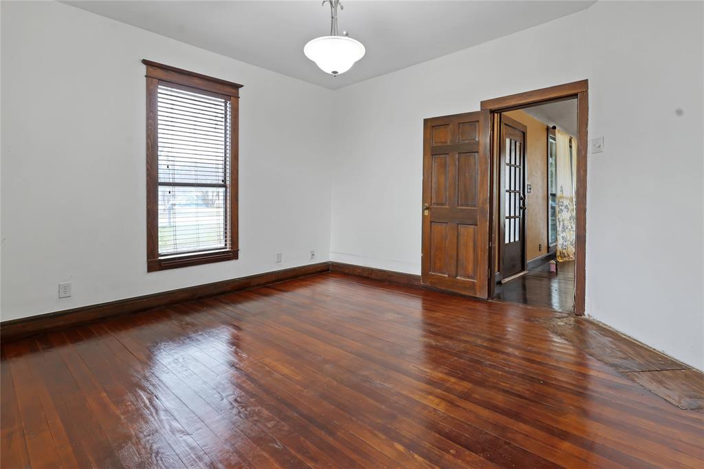 401 West Maple Street Whitewright, TX 75491 - Photo 3 of 31 an empty room with wooden floor and windows