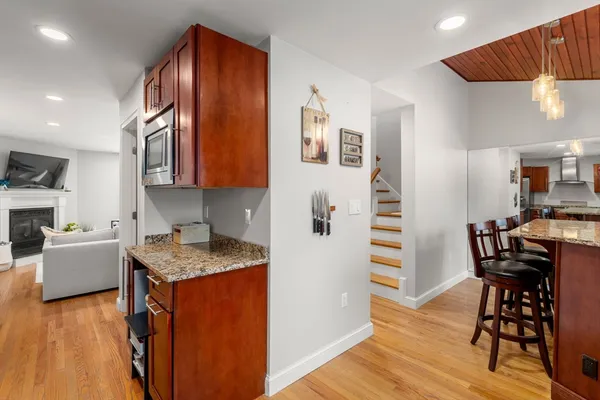 a kitchen with a table chairs refrigerator and cabinets