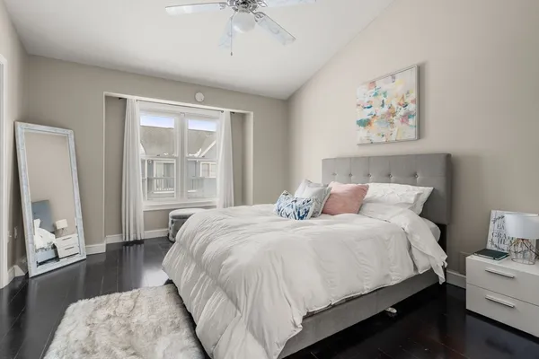 a bedroom with bed and a large window
