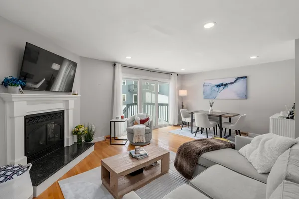 a living room with furniture a fireplace and a flat screen tv