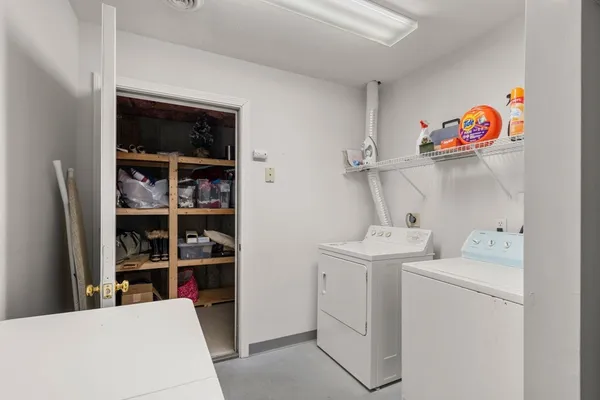 a view of storage and utility room with washer and dryer