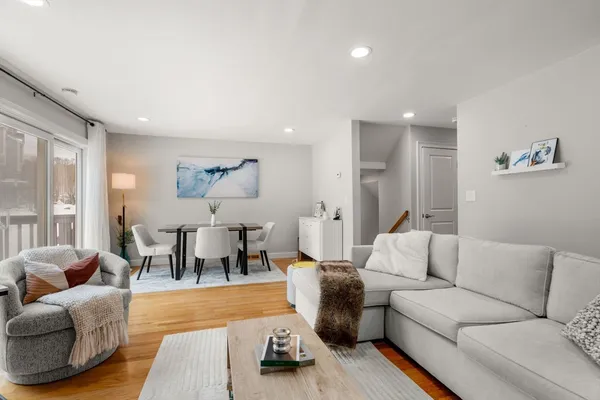 a living room with furniture and wooden floor