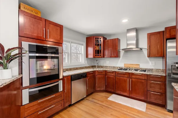 a kitchen with stainless steel appliances granite countertop a stove and a sink