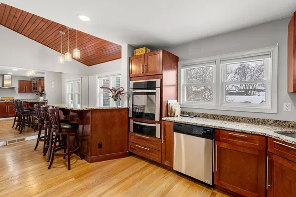 a kitchen with stainless steel appliances granite countertop a stove and a refrigerator