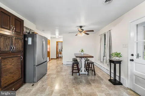 a view of kitchen with furniture and refrigerator