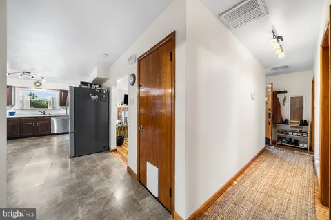 a view of a hallway with living room
