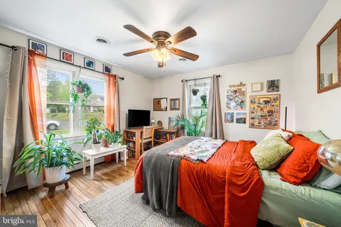 a bedroom with a bed and a large window