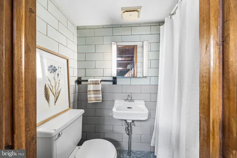 a bathroom with a sink toilet