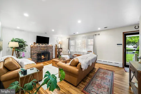 a living room with furniture fireplace and flat screen tv