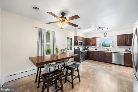 a kitchen with a table and chairs in it