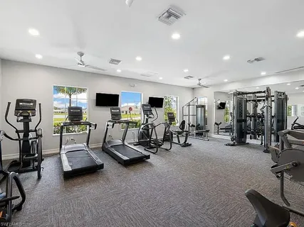 a room with furniture a table and large windows
