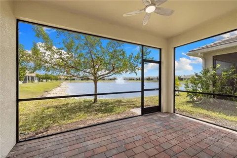 a view of a floor to ceiling window and a tree in a room