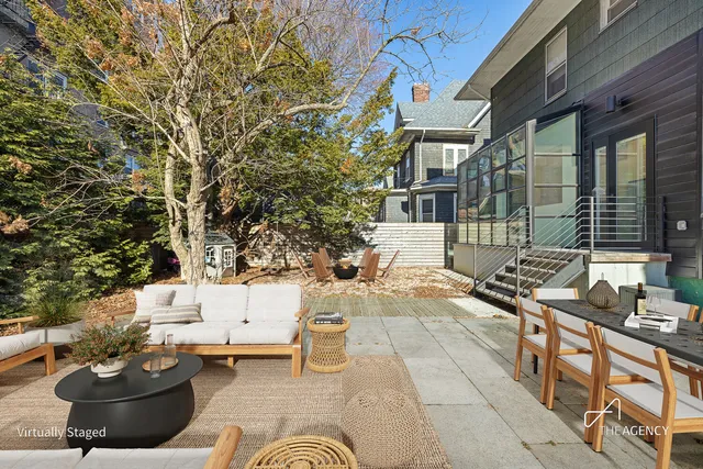 a view of a patio with couches table and chairs and potted plants