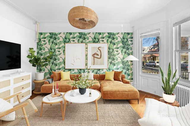 a living room with furniture potted plant and a window