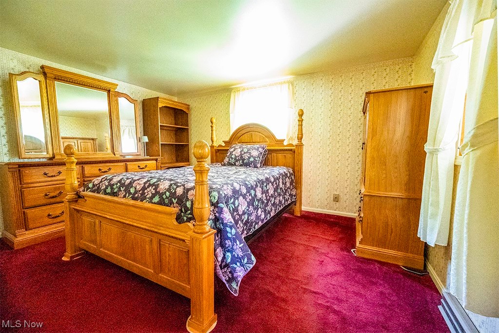 349 Johnson Plank Road Warren, OH 44481 - Photo 24 of 31 Bedroom with wallpapered walls and dark carpet