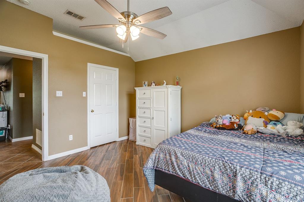 1050 Hampel Road Palmer, TX 75152 - Photo 32 of 35 a bedroom with a bed and wooden floor