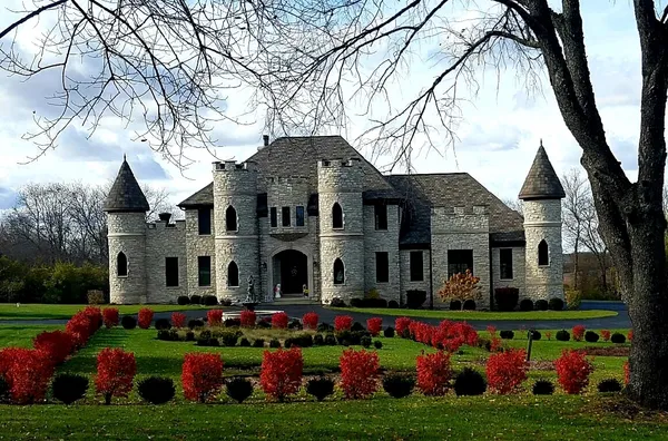 a front view of house with yard and outdoor seating