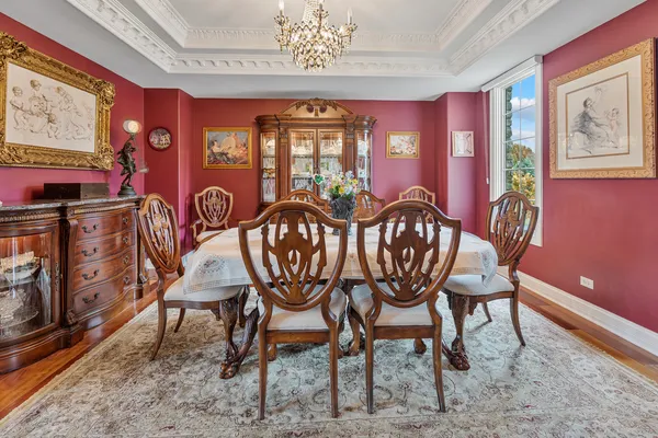 a living room with furniture a rug a kitchen view and a fireplace