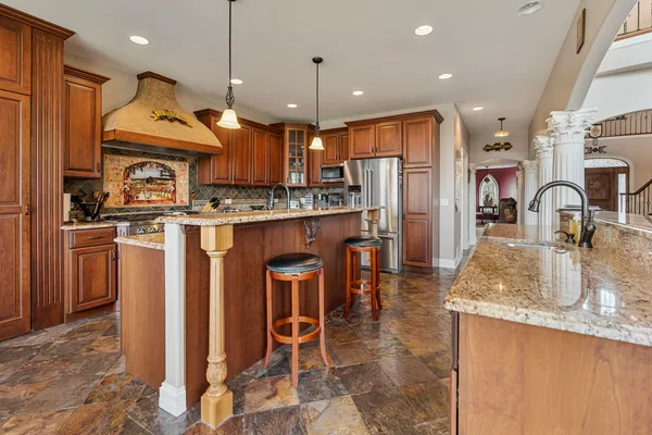 a view of a kitchen area with furniture and wooden floor