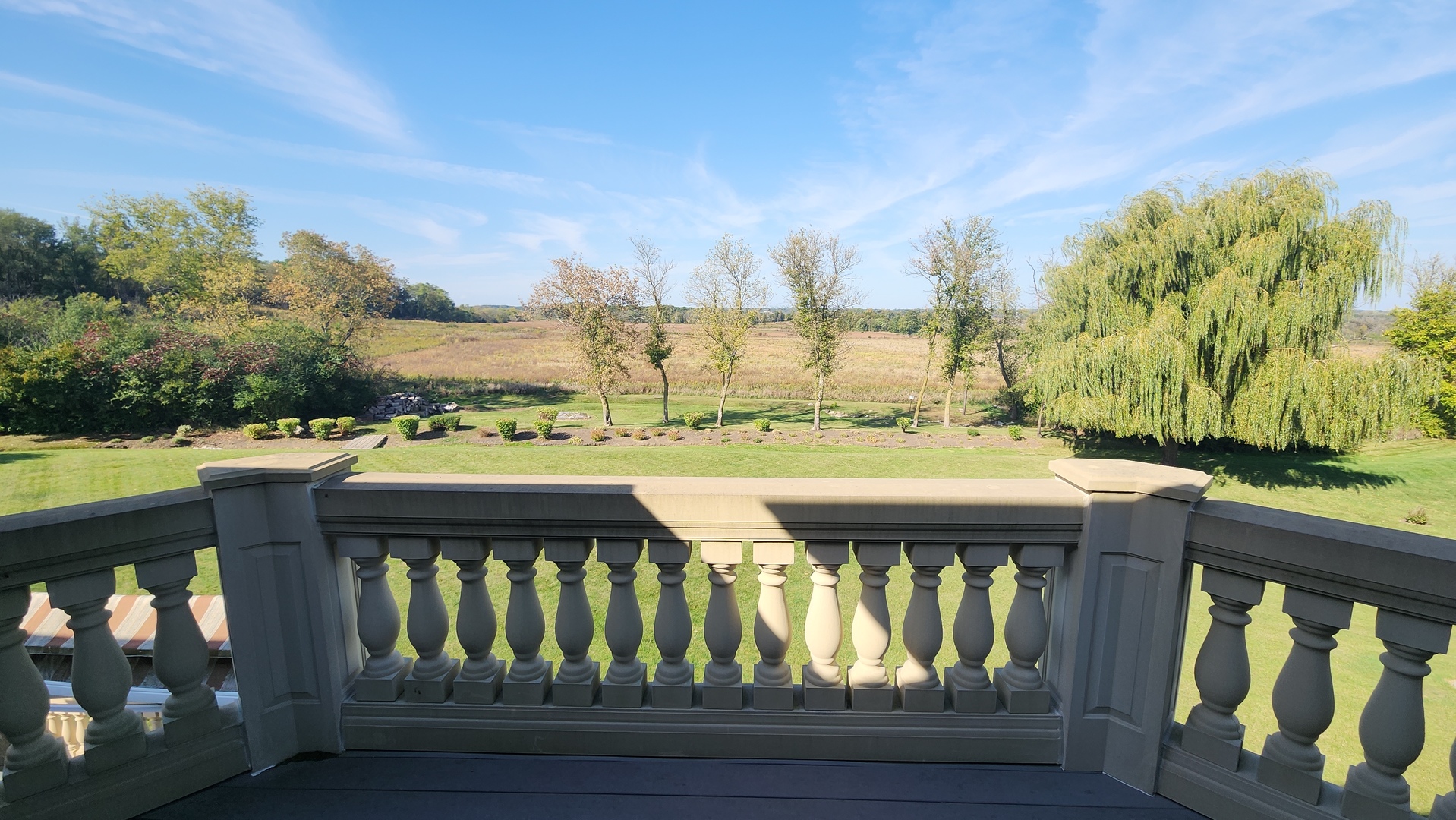 4220 Northgate Drive Spring Grove, IL 60081 - Photo 100 of 105 a view of a balcony with wooden floor and iron stairs
