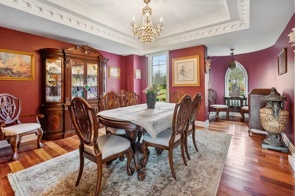a living room with furniture a fireplace and a dining table