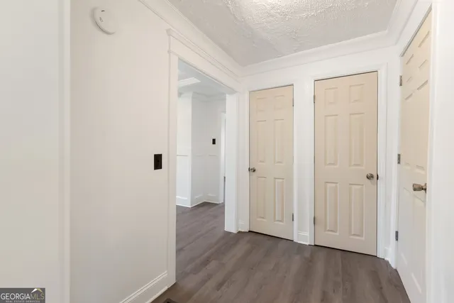a view of a hallway with wooden floor
