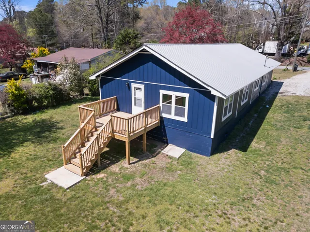 a aerial view of a house with yard and a garden