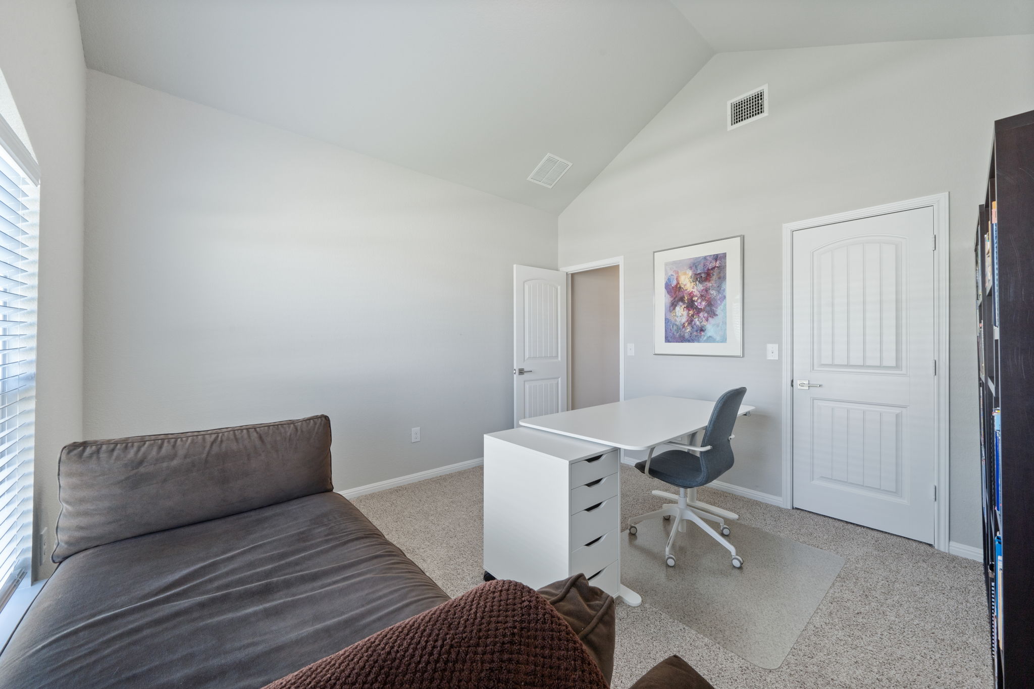 2412 Starhill Ranch Street Georgetown, TX 78628 - Photo 5 of 40 A well-lit, quiet study with vaulted ceilings, ideal for productive work.