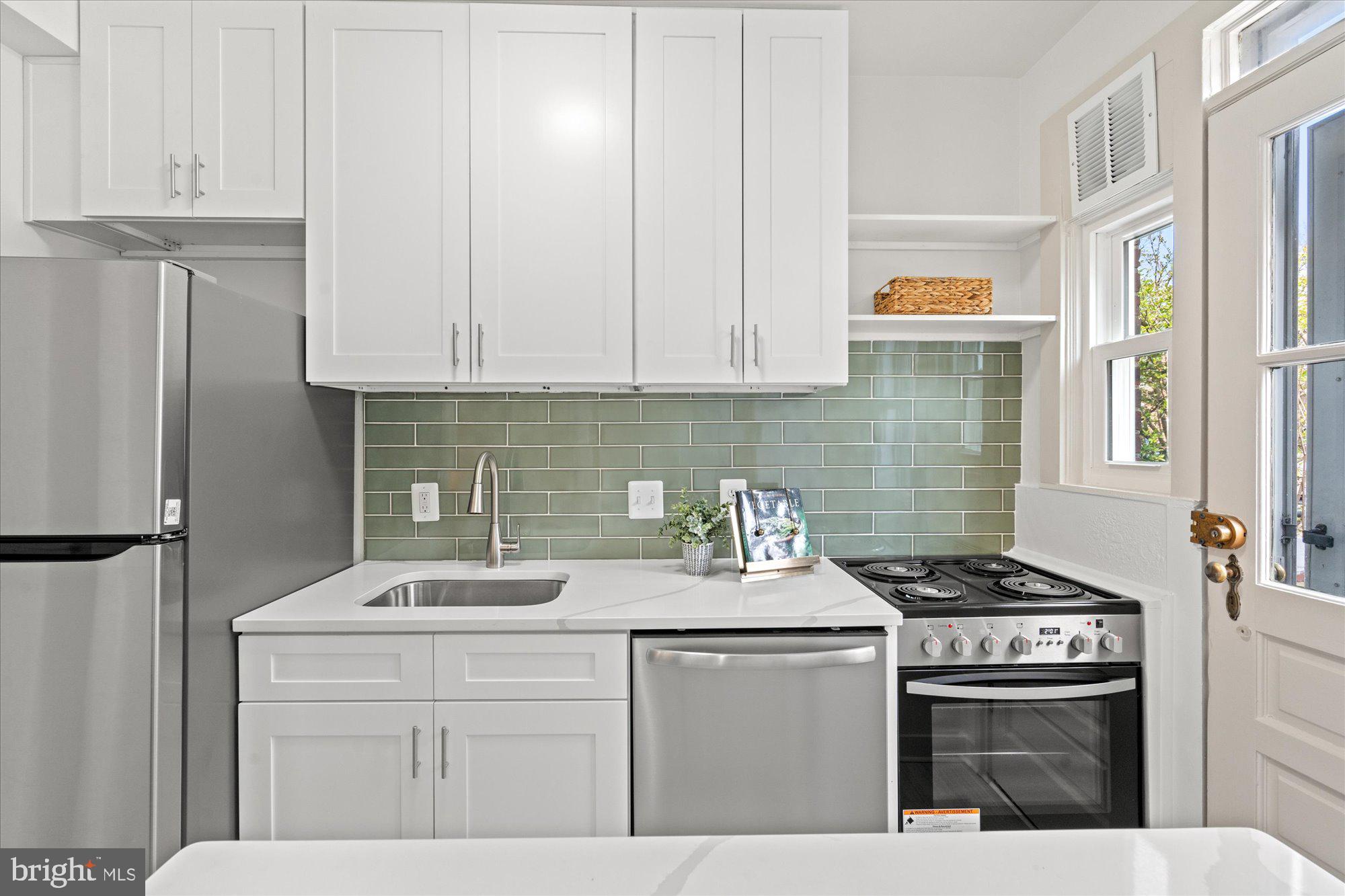 12 Ashby Street, Unit F Alexandria, VA 22305 - Photo 12 of 20 a kitchen with stainless steel appliances a sink stove and refrigerator