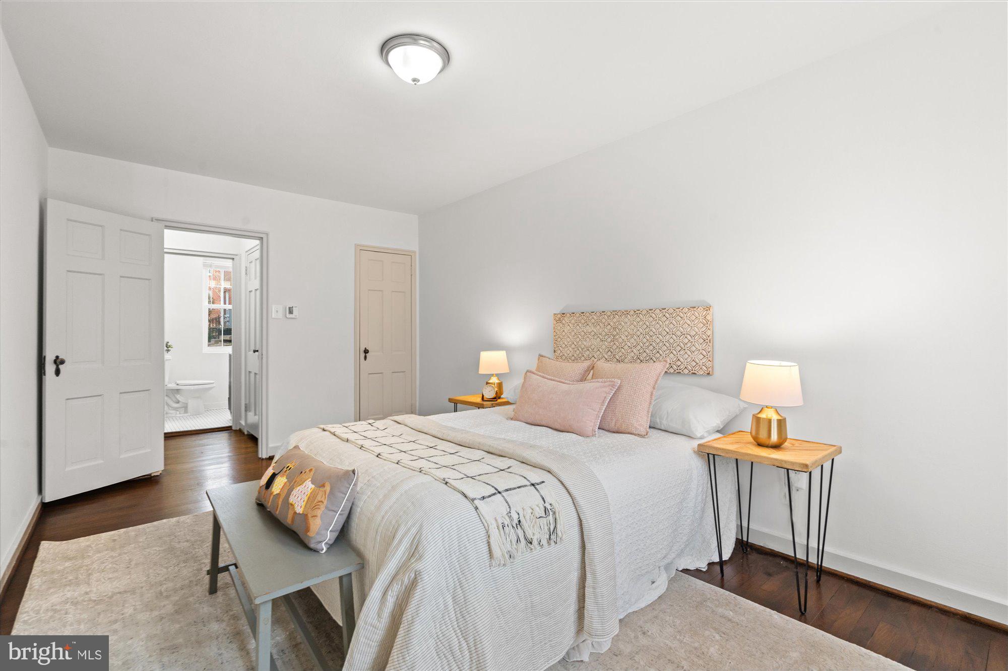 12 Ashby Street, Unit F Alexandria, VA 22305 - Photo 15 of 20 a bedroom with a bed and a lamp