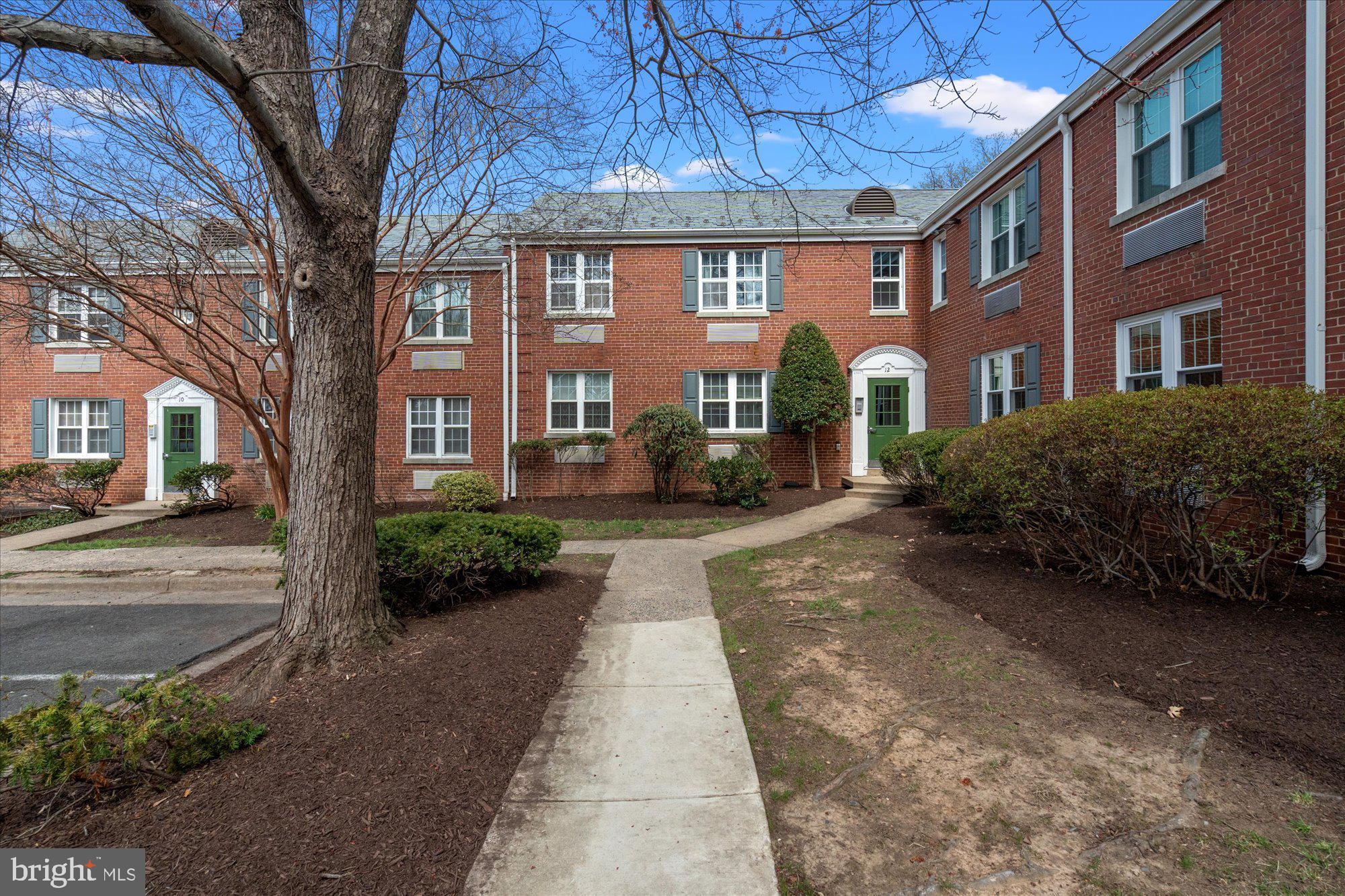 12 Ashby Street, Unit F Alexandria, VA 22305 - Photo 18 of 20 a view of a brick building next to a road