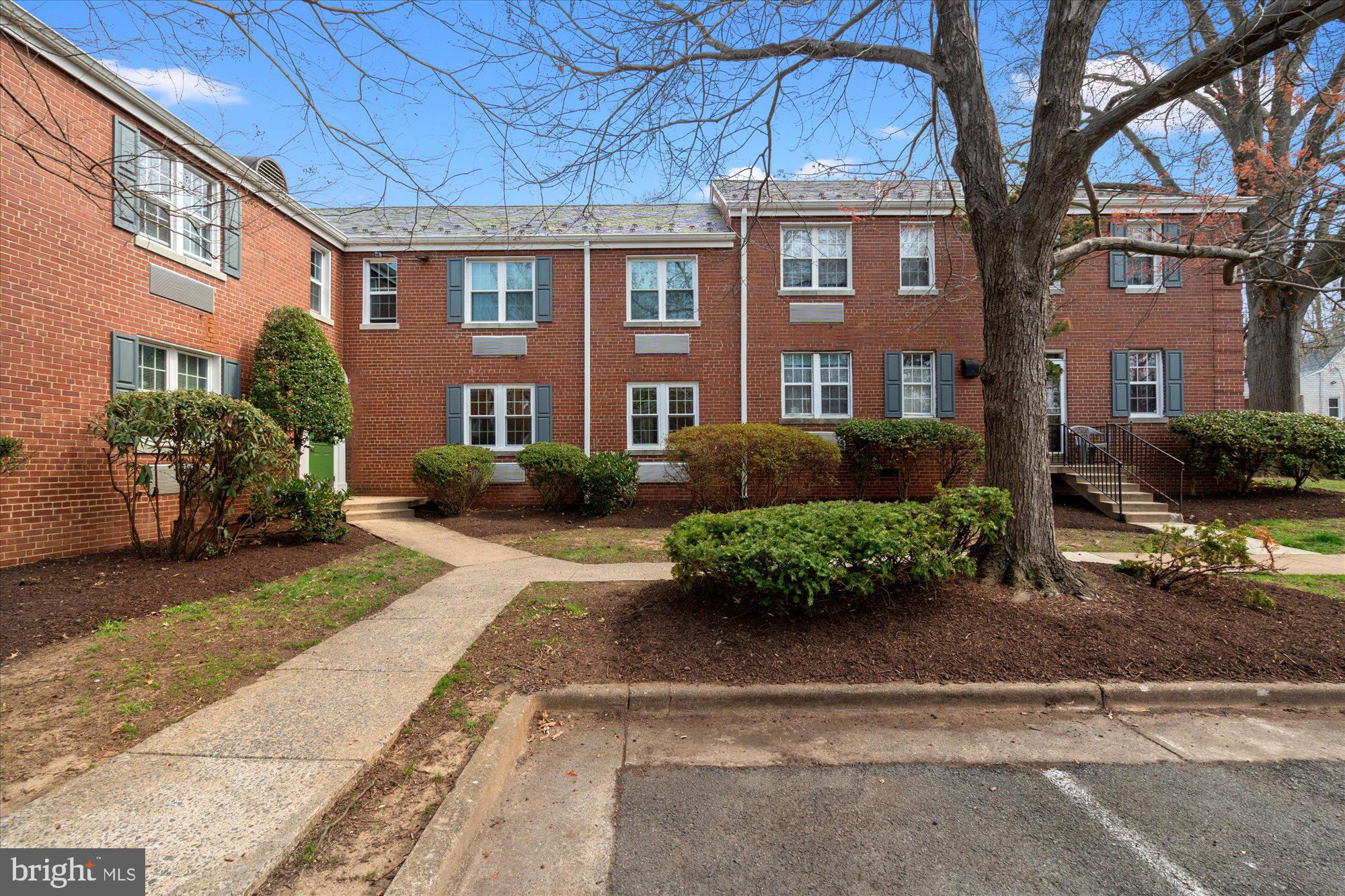 12 Ashby Street, Unit F Alexandria, VA 22305 - Photo 19 of 20 a front view of a residential apartment building with a yard