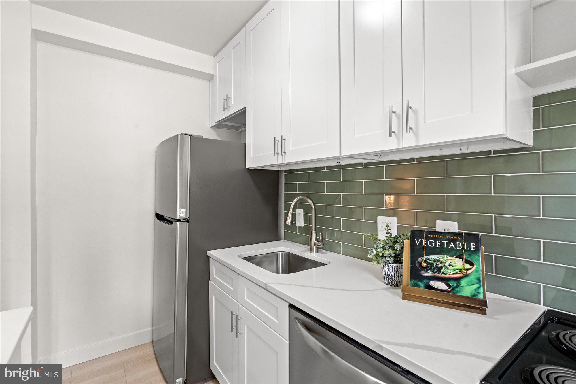 12 Ashby Street, Unit F Alexandria, VA 22305 - Photo 8 of 20 a kitchen with refrigerator and cabinets