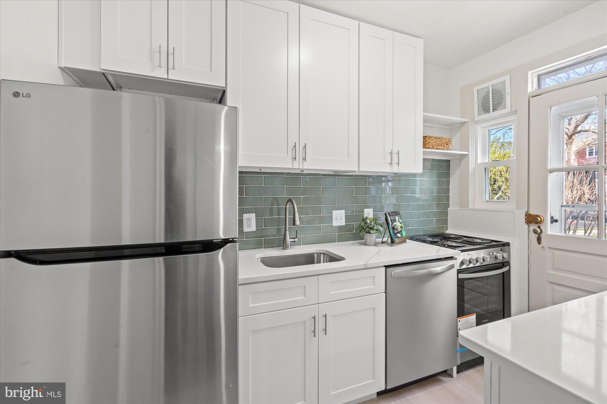 12 Ashby Street, Unit F Alexandria, VA 22305 - Photo 9 of 20 a kitchen with a sink a stove and cabinets