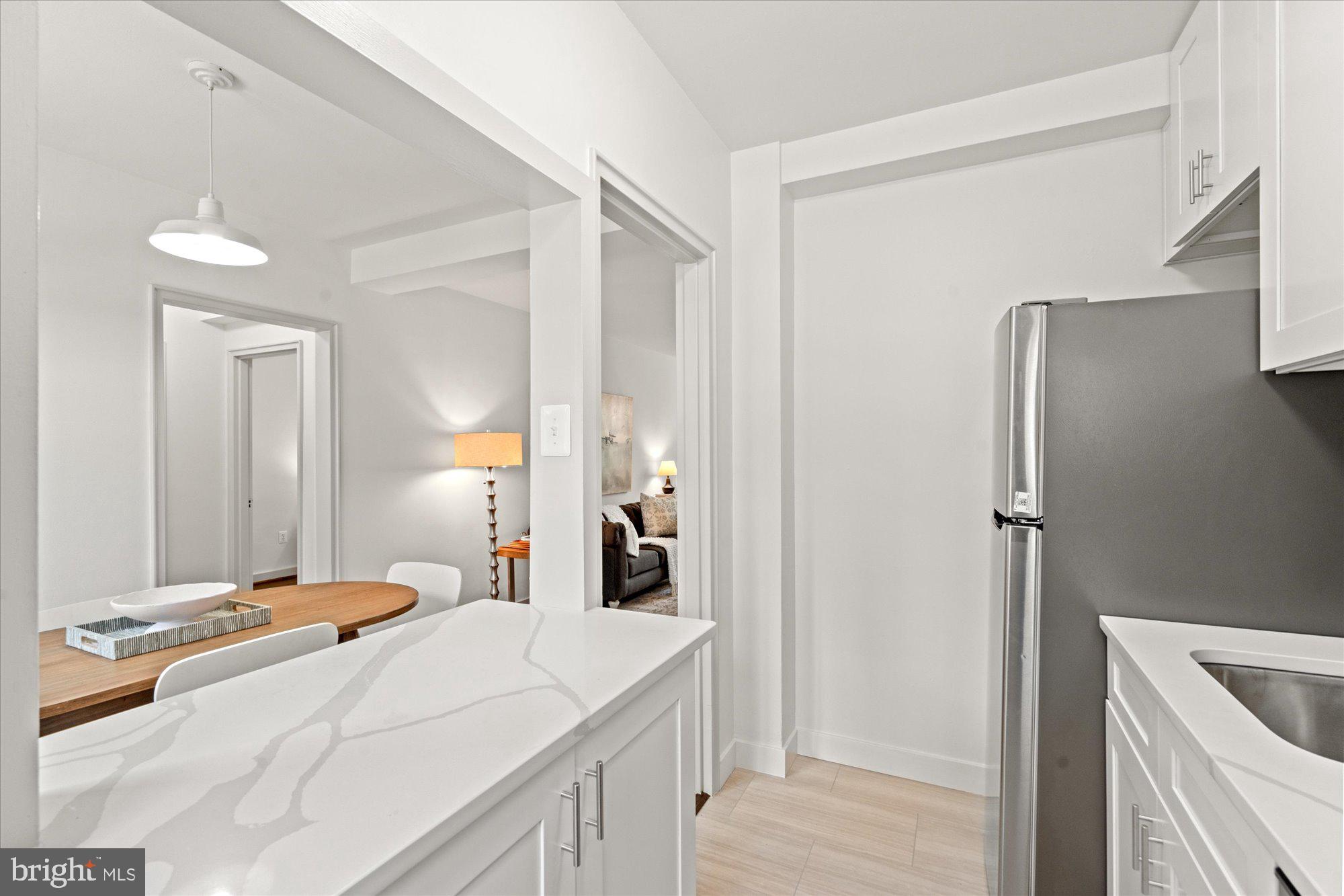 12 Ashby Street, Unit F Alexandria, VA 22305 - Photo 10 of 20 a en suite bathroom with a double vanity sink and mirror