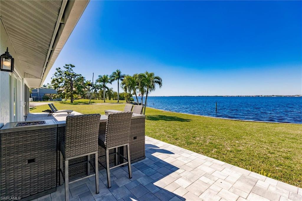 138 Riverview Road Fort Myers, FL 33905 - Photo 10 of 50 View of patio with a water view and an outdoor bar