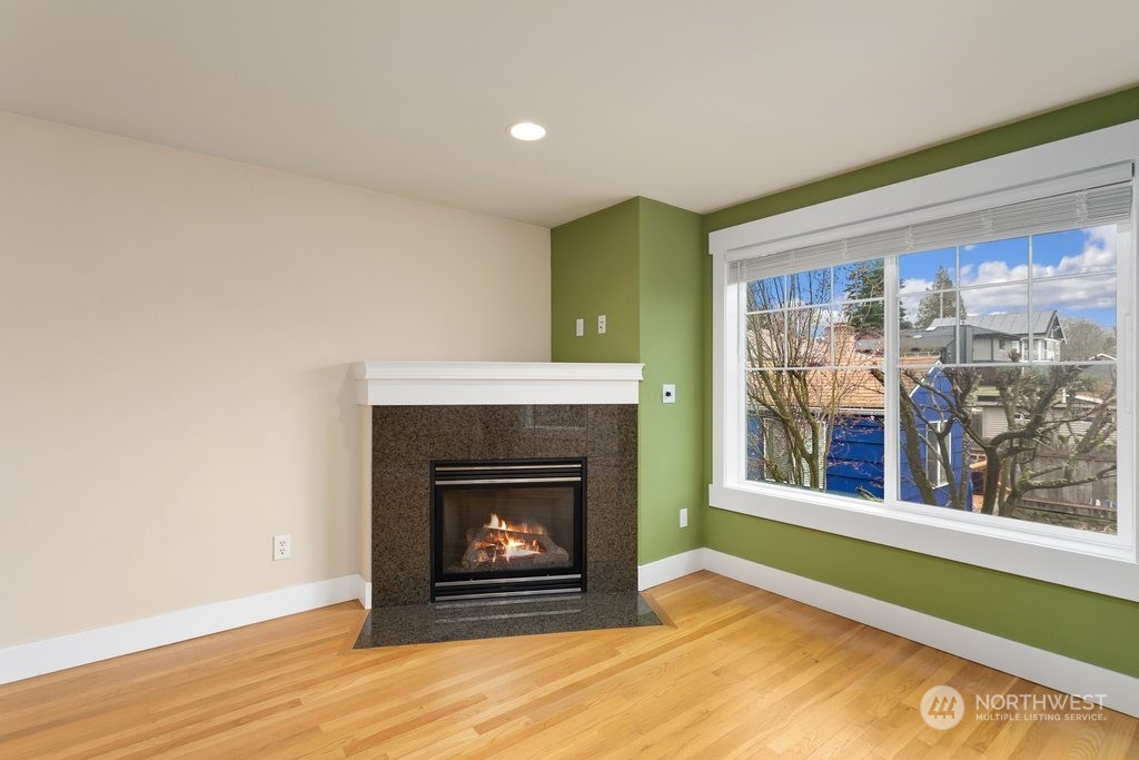 910 Northwest 85th Street, Unit A Seattle, WA 98117 - Photo 12 of 29 a living room with a fireplace