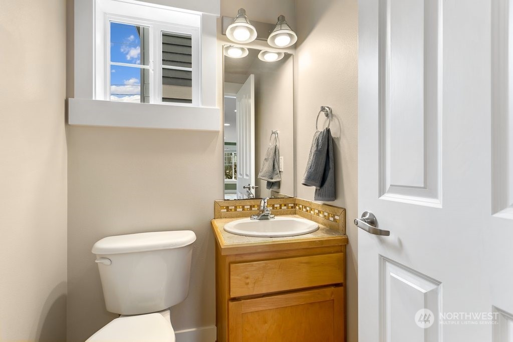 910 Northwest 85th Street, Unit A Seattle, WA 98117 - Photo 14 of 29 a bathroom with a toilet sink and mirror