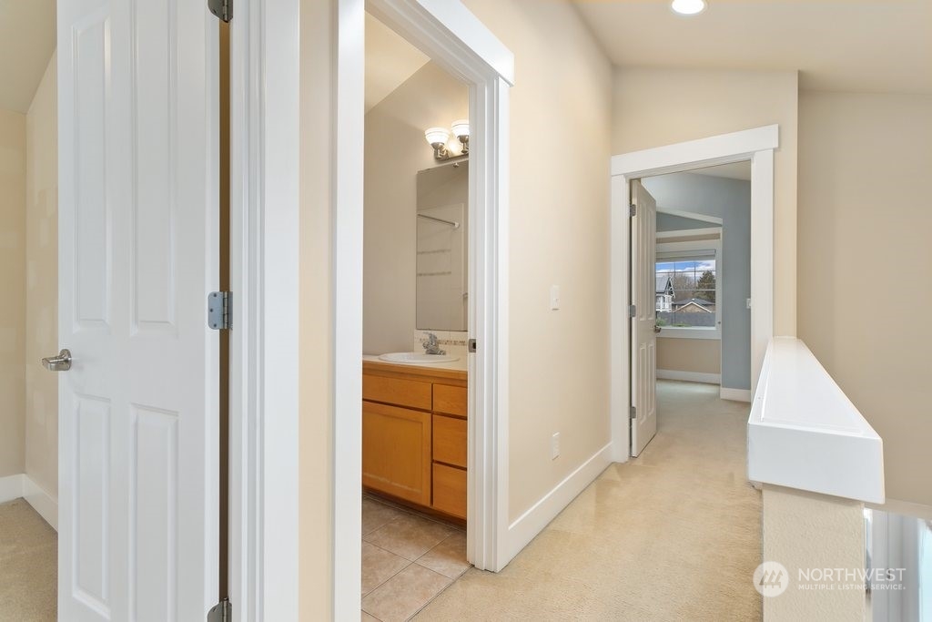 910 Northwest 85th Street, Unit A Seattle, WA 98117 - Photo 21 of 29 a view of a bathroom from a corridor
