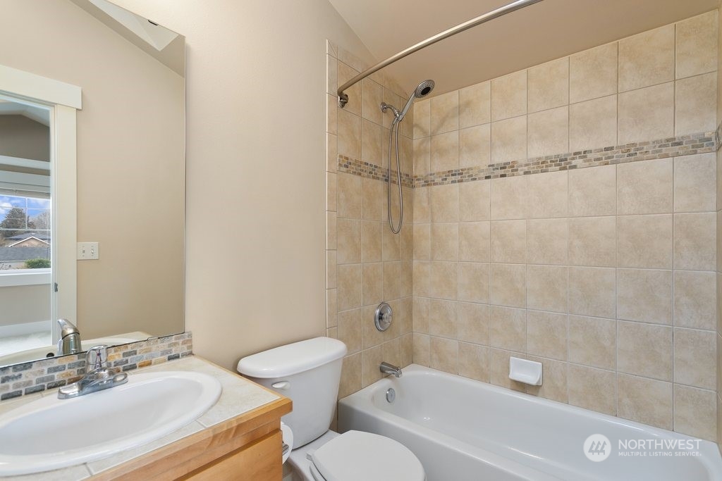 910 Northwest 85th Street, Unit A Seattle, WA 98117 - Photo 24 of 29 a bathroom with a sink toilet and shower