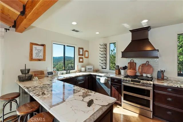 a kitchen with granite countertop a sink and a stove