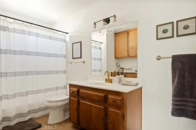 a kitchen with white cabinets and sink