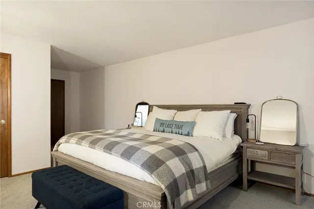 a bedroom with a bed and dresser