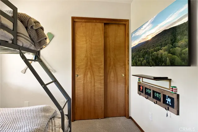 a bedroom with a bed and a mirror